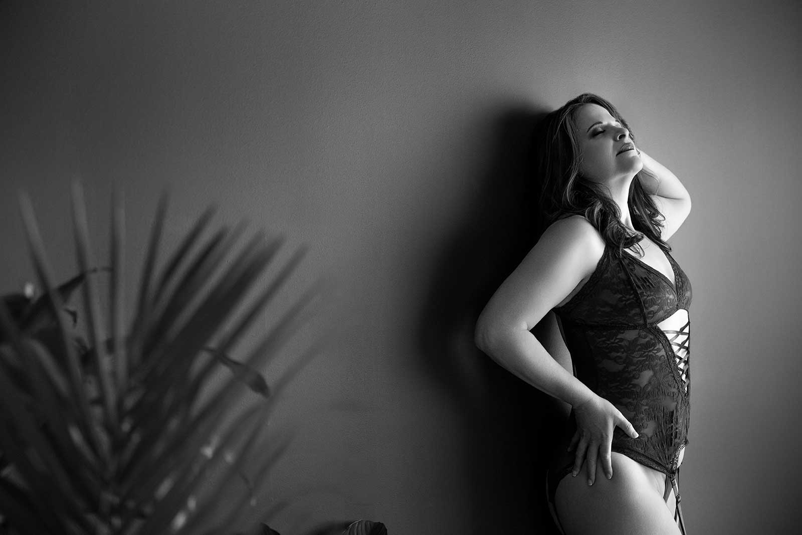 Woman Standing Against Gray Wall Boudoir Session